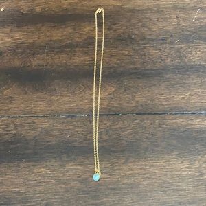 I am selling a gold necklace with a blue stone